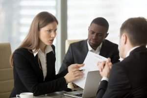 Dispute between people in business attire, Two men, one woman, African American Man, Woman frowning