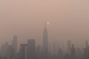 Hazy smoky view of NYC, Empire State Building, Canada Wildfires, Climate Change