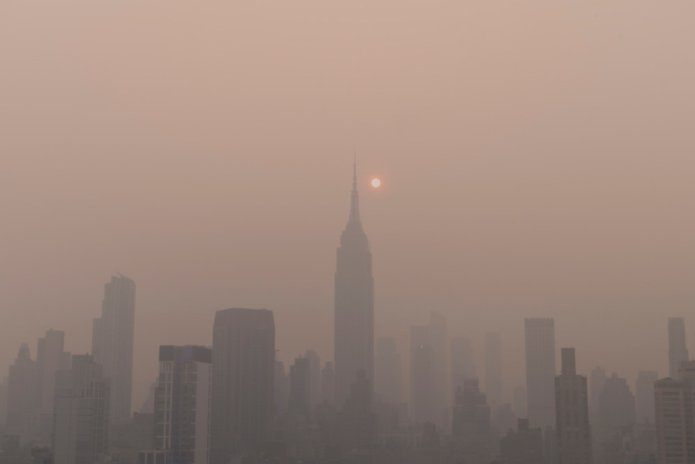 Hazy smoky view of NYC, Empire State Building, Canada Wildfires, Climate Change